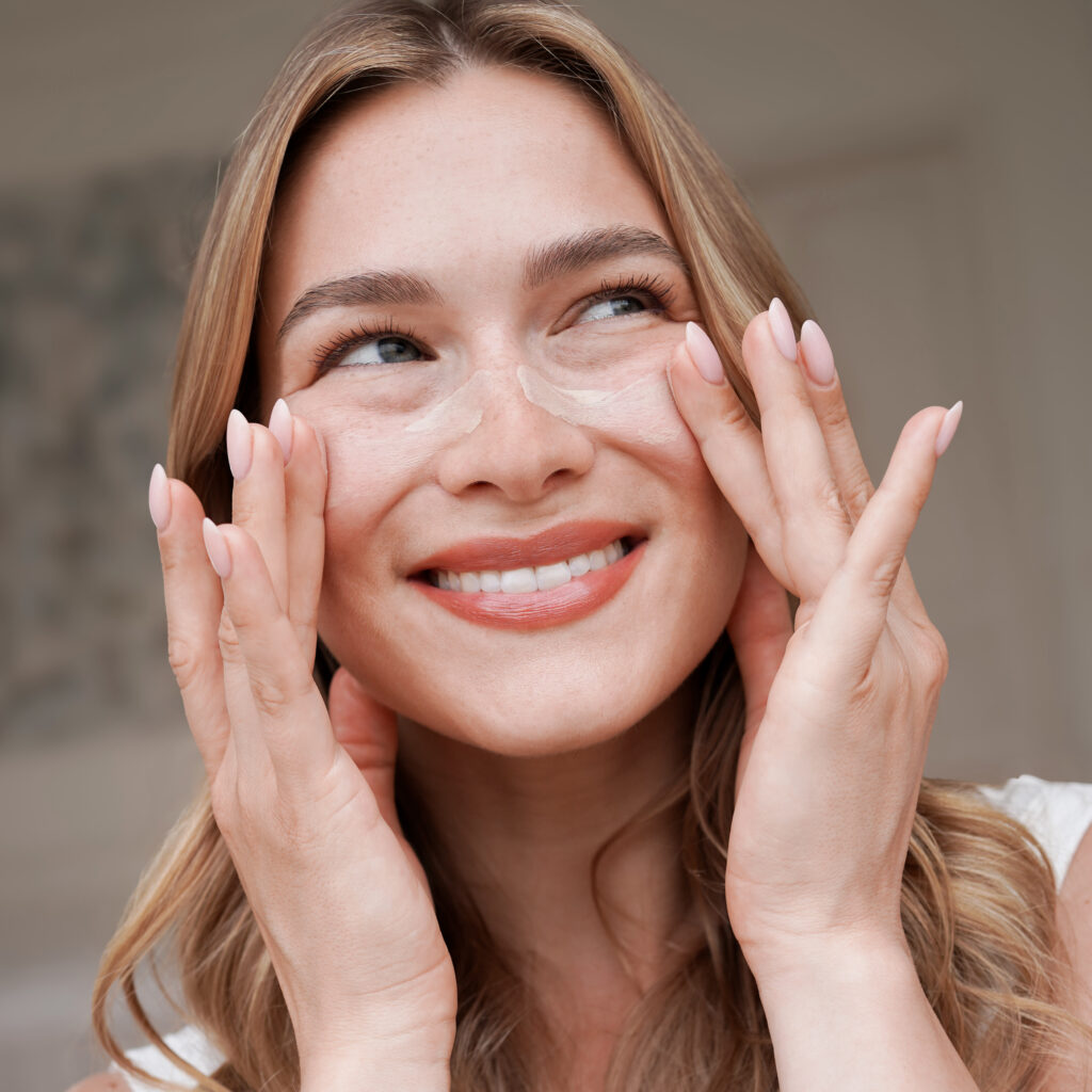 Woman putting on Light protection cream SPF 50 with Tinted Sunscreen pigment coloring, capacity 50 ml